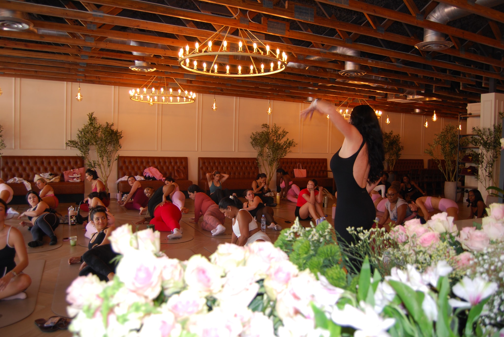 A Pilates instructor leading a class at a Glow Wellness event